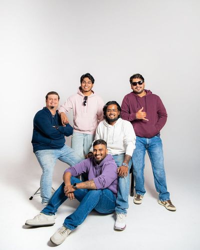 Group of diverse people in a light yoga studio smiling.